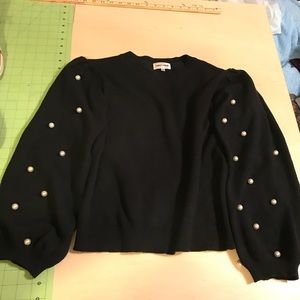 Cute cropped sweater with bell pearl sleeves!